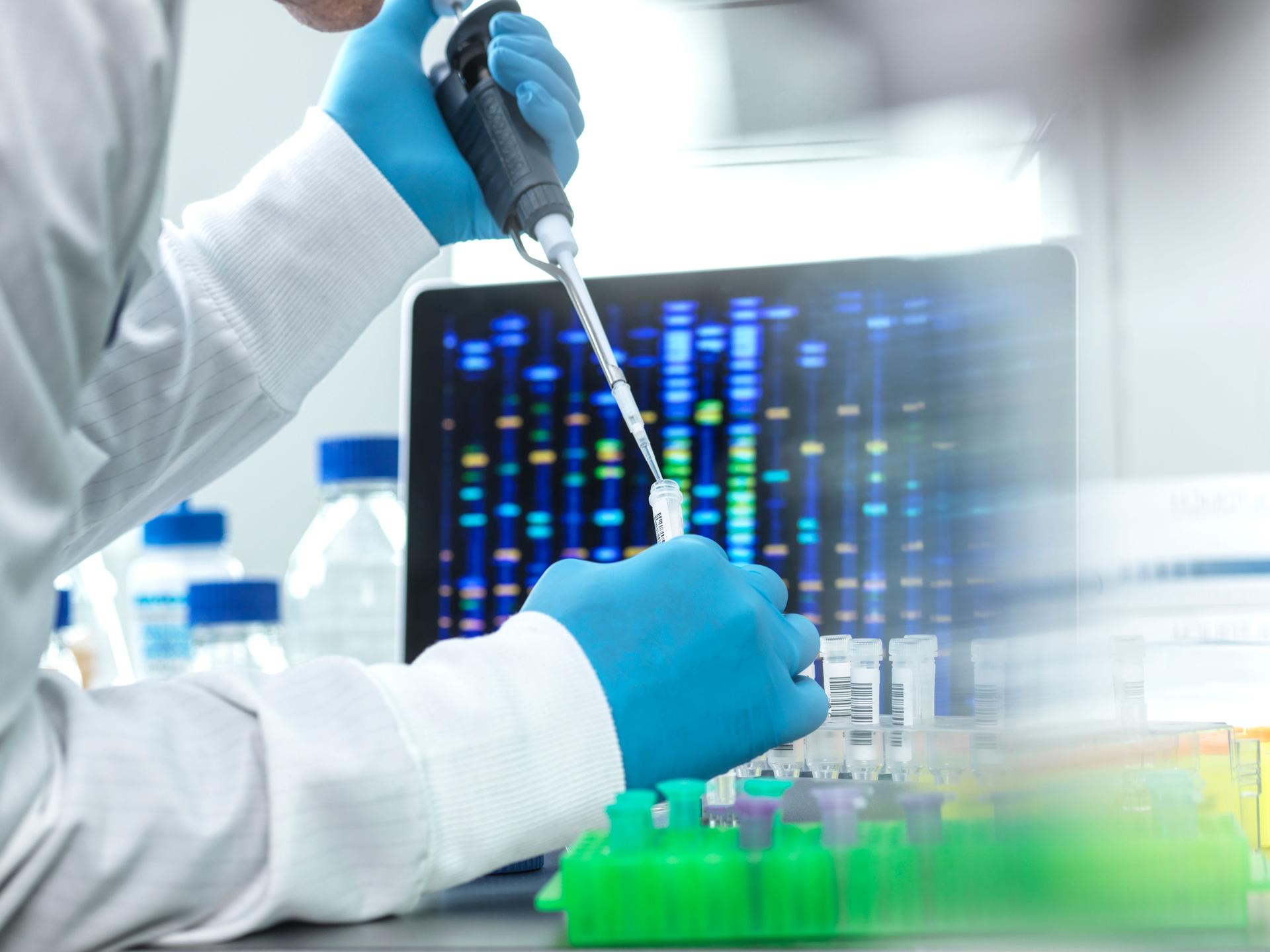 Scientist pipetting sample into a vial for DNA testing