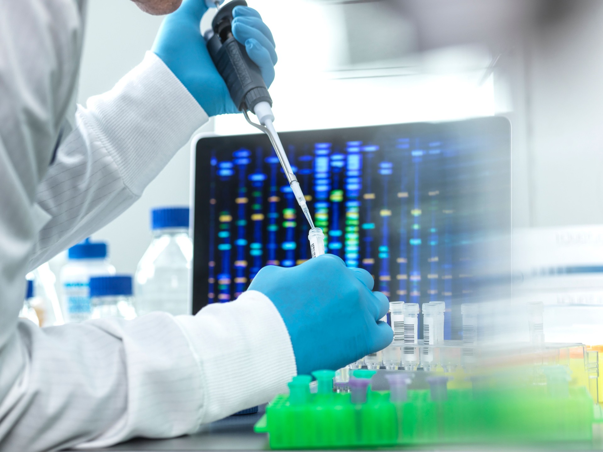Scientist pipetting sample into a vial for DNA testing